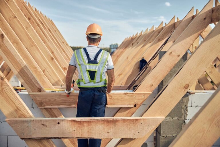 Timber roof trusses being installed on a house.
